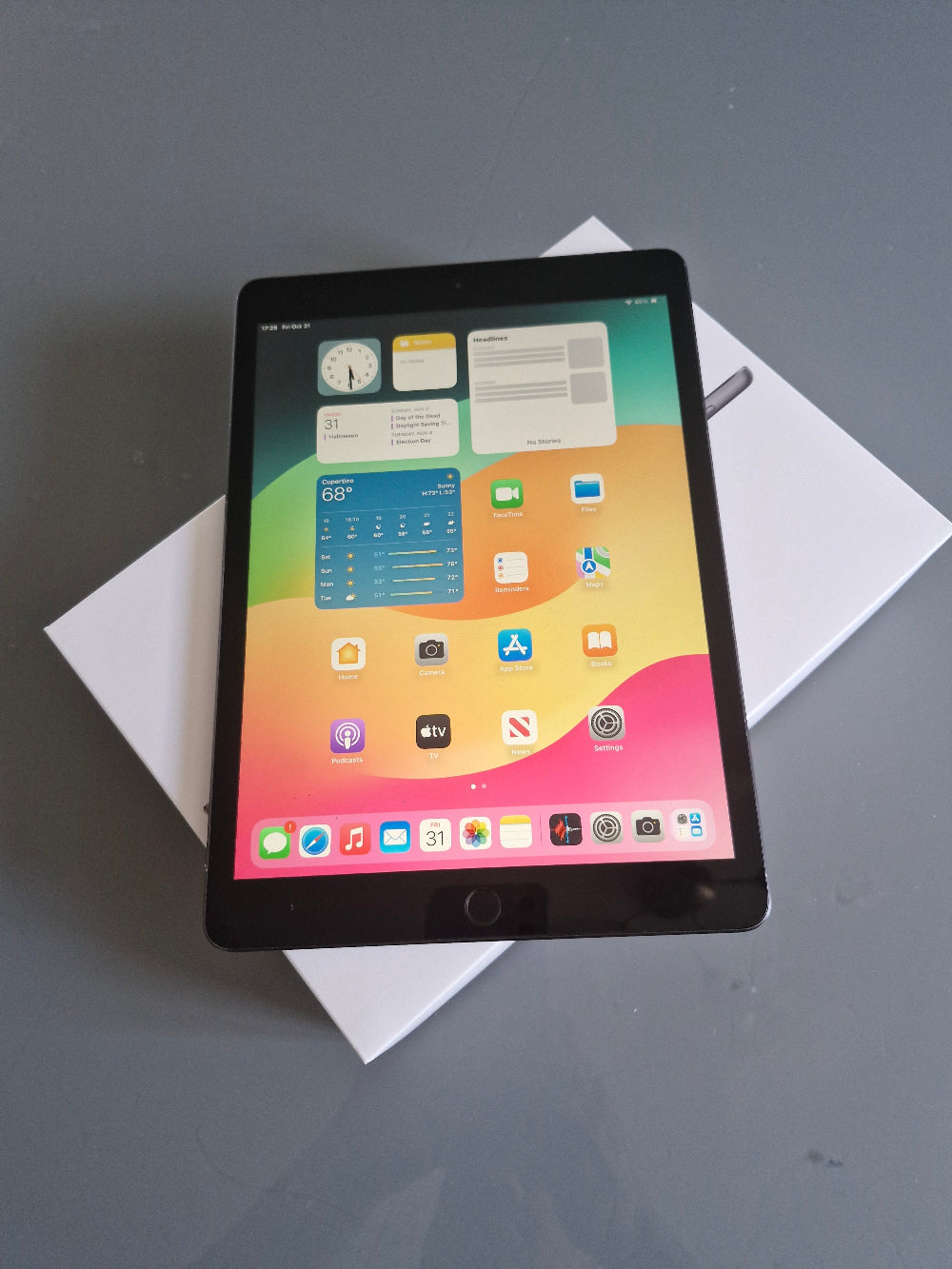 Apple iPad 7 32GB Wifi Space Grey - New Battery, Screen Protector (Fair) iPad Tablet with a colorful display on a white surface