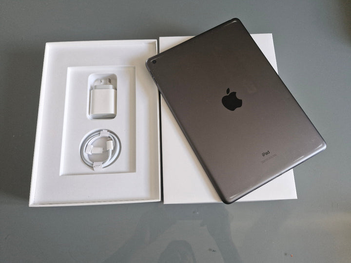 Apple iPad 7 32GB Wifi Space Grey - New Battery, Screen Protector (Fair) adapter on a gray surface