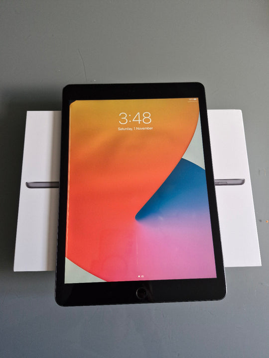 Apple iPad 7 32GB Wifi Space Grey - New Battery (Imperfect) Tablet with colorful display on a stand against a gray background