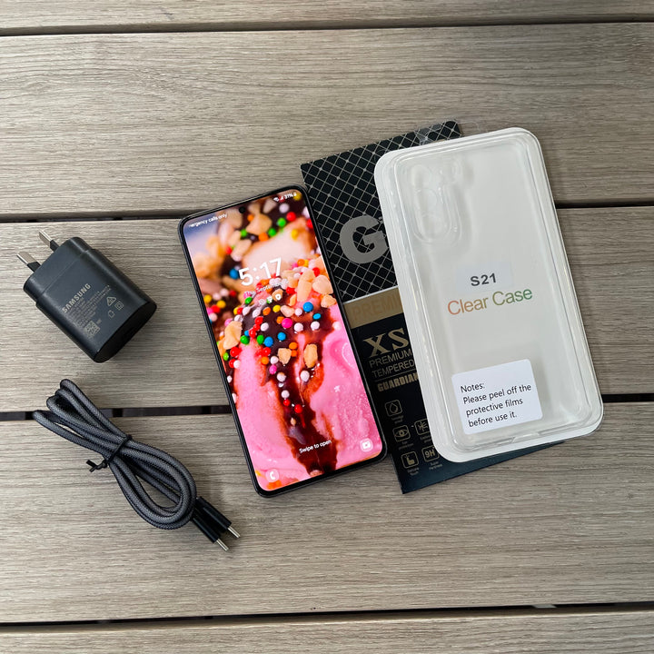 Samsung S21 Smartphone with screen protector, case, and charging cable on a wooden surface at SmartGear NZ New Lynn Auckland