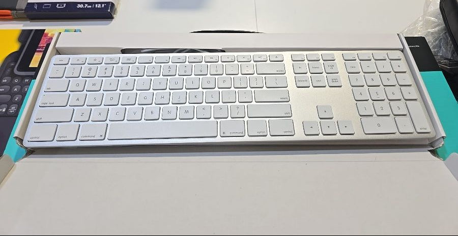 White keyboard on a desk with a blurred background