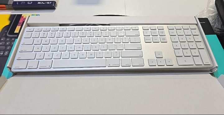 White keyboard on a desk with a blurred background